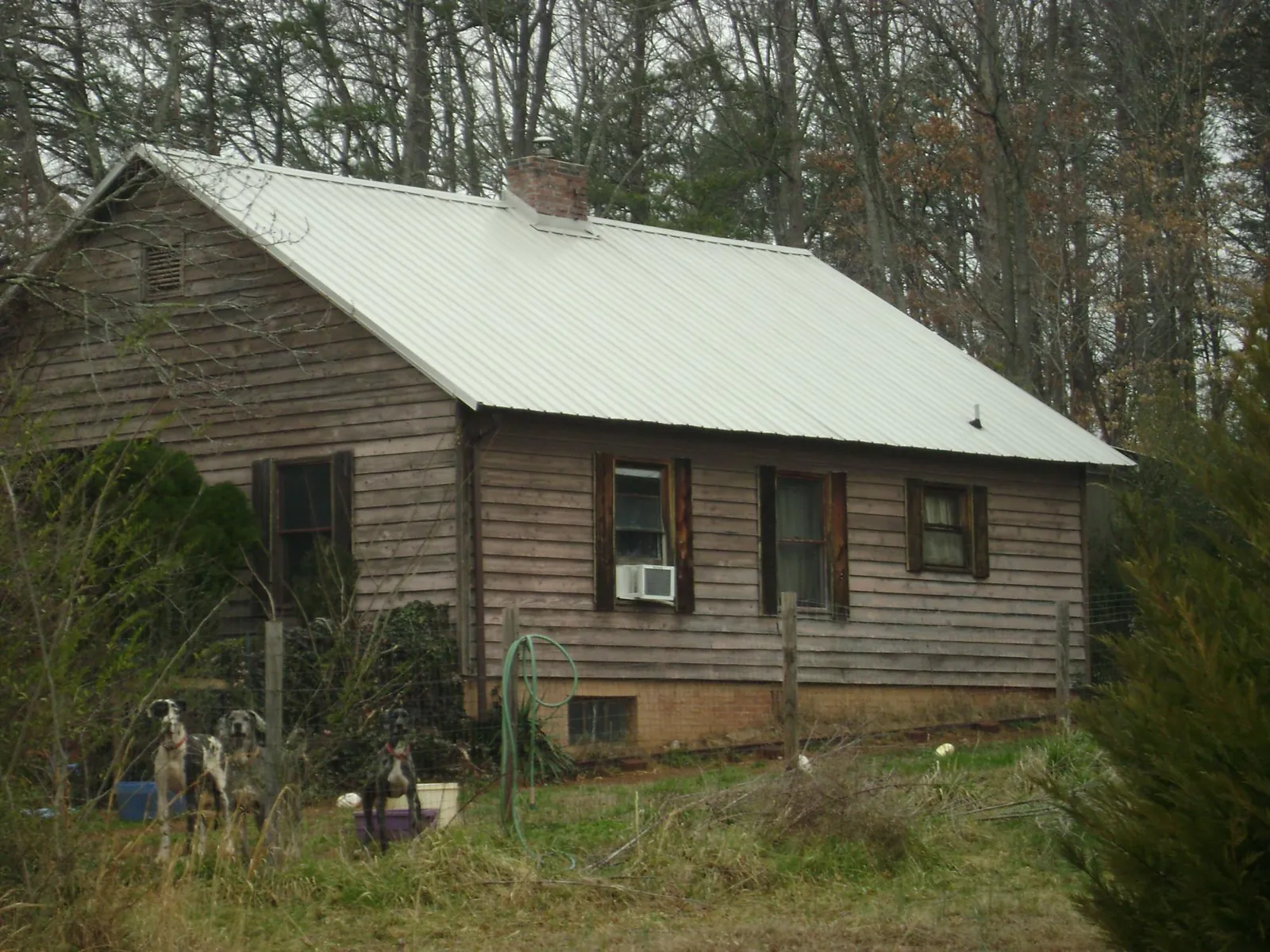 White metal roof on an old wood sided farmhouse, from a Metal Roof Installation job in Holtsville